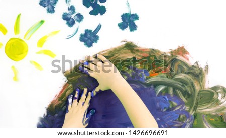children hand paint a picture with paints on white background. creativity in children's painting

