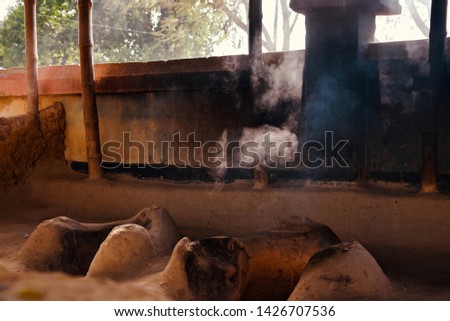 Traditional clay made stoves with smoke unique photo