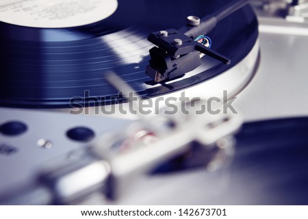 Turntable player with musical vinyl record. Useful for DJ, nightclub and retro theme.