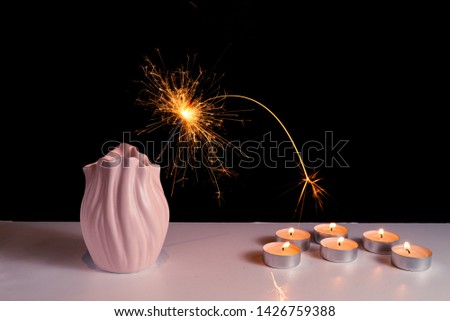Burning candles on a white background next to the fireworks. Obon festival. Diwali festival