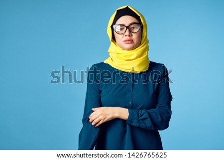    woman in a veil with glasses on a blue background                            