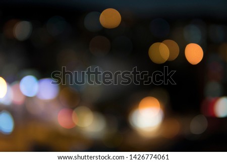 Abstract urban night light bokeh. Defocused city background.