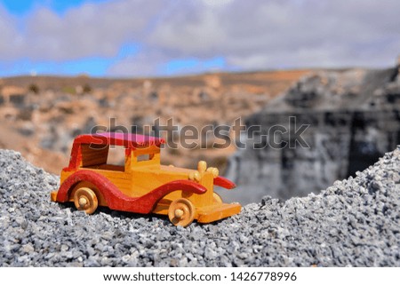 Conceptual Photo Picture of a toy car in the dry desert