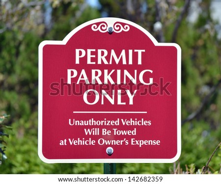 A red sign reading Permit Parking Only