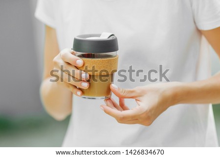 Female hands hold reusable coffee mug. Take your coffee to-go with reusable travel mug. Zero waste. Sustainable lifestyle concept.
 Royalty-Free Stock Photo #1426834670