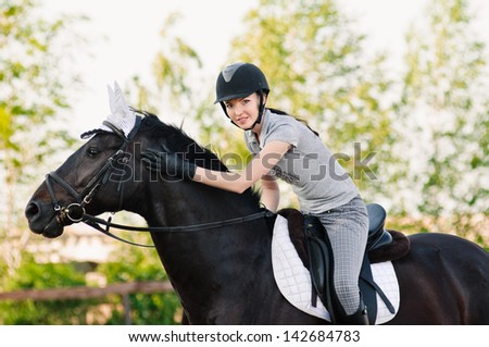 riding young woman portrait on horse in outdoor Royalty-Free Stock Photo #142684783