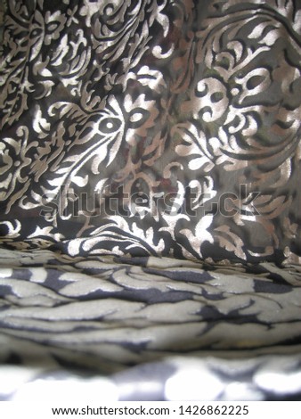 
dramatic drapery of silver pan velvet on black