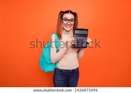 Close up photo beautiful amazing she her lady pretty hairdo hold hand arm calculator best exam result lesson toothy blue back pack wear specs casual pastel pullover clothes isolated orange background