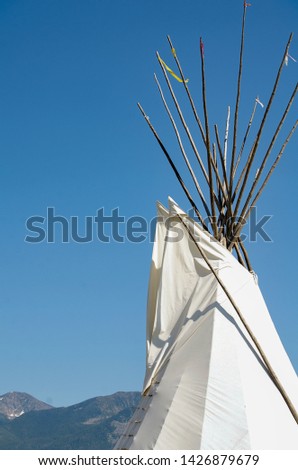 White Canvas Tee Pee Tent Top Isolated Against Bright Blue Sky Background Texture Open Space