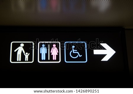 Digital symbol for the toilet for child,men,women and disabled person with black background,Direction and navigation signs in the terminal hall for lost and found and WC restroom in the building.