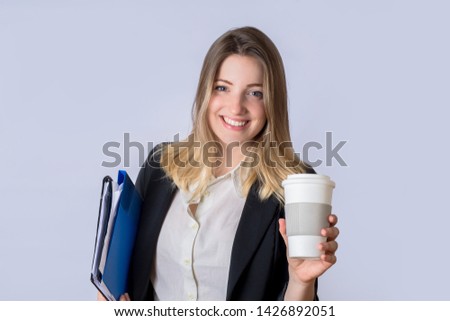 Portrait of young business woman with folder on studio.