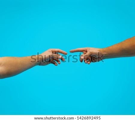 God and Adams hands. Creation of human. Genesis. Touch of god. Spirituality. A section of Michelangelo's fresco Sistine Chapel ceiling. Close-up of man hands on blue background isolated Royalty-Free Stock Photo #1426892495