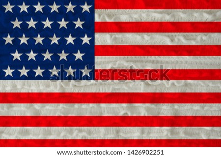 beautiful national flag of the country of america on a soft background texture of knitted wool small wrought linen web