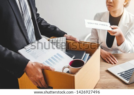 Boss Send a resignation letter to Business man stressing for quit a job packing the box and leaving the office , Resignation concept