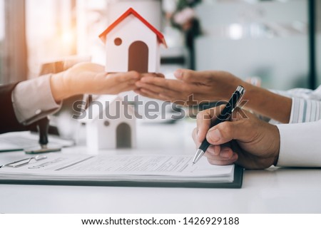 Real estate agents submit documents for customers to sign for a sale contract,real estate concept.
 Royalty-Free Stock Photo #1426929188