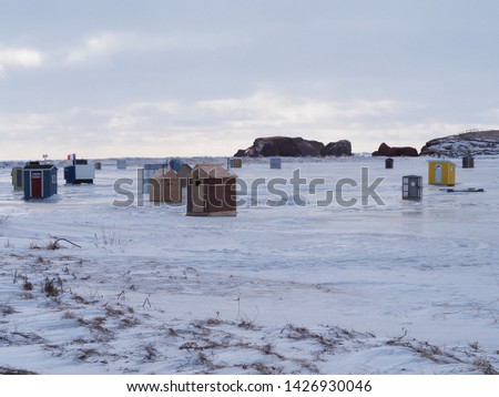 Traditional fishermen's cabins built on ice field in winter season, Magdalen islands, Quebec, Canada