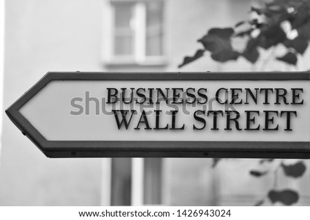 Wall Street direction sign. Business centre information road signage. Wall street is a financial district and the first permanent home of the New York Stock Exchange