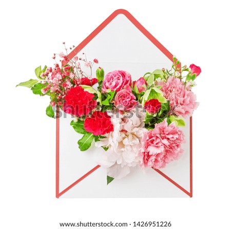 Opened envelope with various beautiful flowers isolated on white background. Festive greeting or love concept.