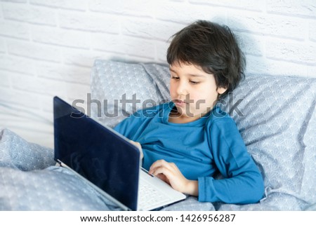 Concept of little businessman, webmaster, programmer, developer, Website designer. Little child and laptop, computer notebook
