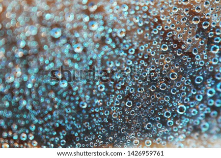 Macro of water droplet on colorful surface