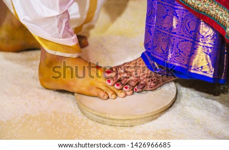 Indian Hindu marriage ritual,Bride place foot on Groom foot and afterwards man repeats the same,a part of ceremony