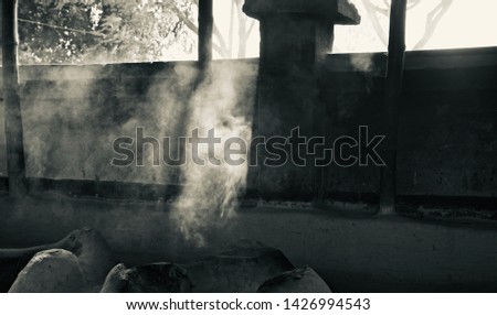 Blurry white smoke of a clay made stove unique photo
