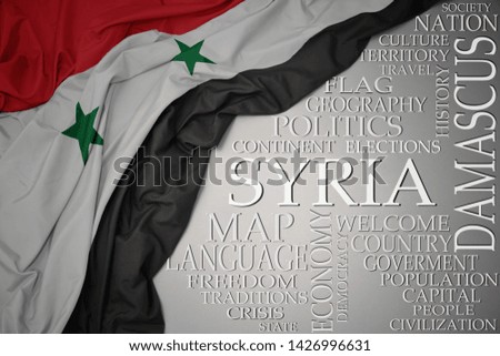 waving colorful national flag of syria on a gray background with important words about country . concept