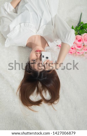 Portrait of young asian woman holding vintage camera for take a photo, Woman photographer in action on white background.