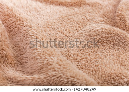 The material texture of the beige blanket