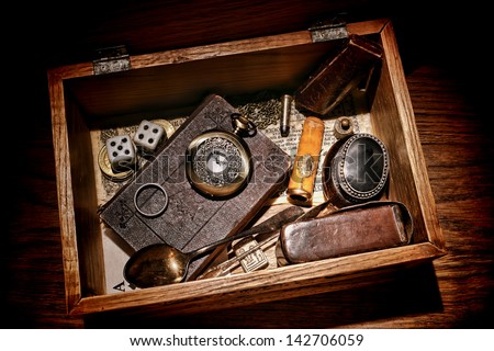 American West legend western pioneer memorabilia and souvenir collection with old bible and antique pocket watch with everyday object in a vintage keepsake wood box Royalty-Free Stock Photo #142706059