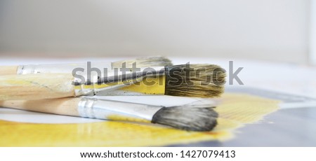 Creative background with painting brushes.