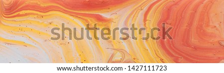 photography of abstract marbleized effect background. gold, yellow, orange and white creative colors. Beautiful paint