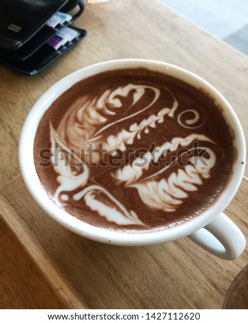 Cup of mocha with latte art foX