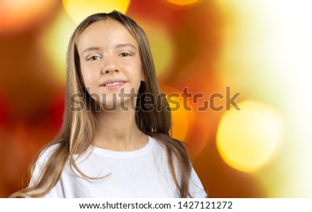 Little girl with blue eyes and blonde hair smiling, looking in camera 