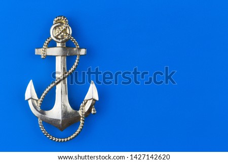 metal anchor on a blue background