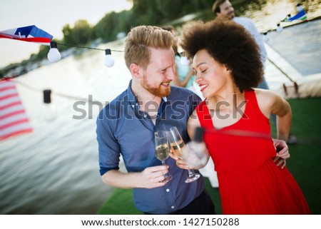 Romantic happy couples dancing and drinking at party
