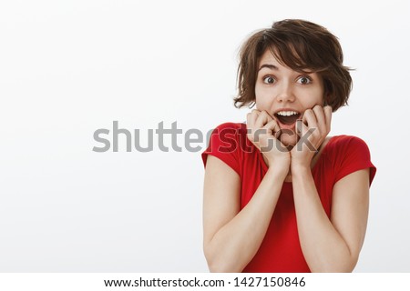 Impressed fascinated caucasian emotive enthusiastic girl short haircut open mouth astonished gasping surprised hold hands face-line stare camera excited look admiration happiness lucky news Royalty-Free Stock Photo #1427150846