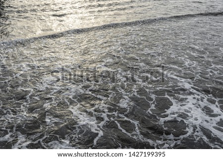 Beautiful golden texture of sea water. Horizontal color photography.