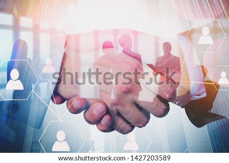 Handshake of business people with double exposure of team members in modern office and social network icons. Concept of social connection in business and HR. 3d rendering toned image