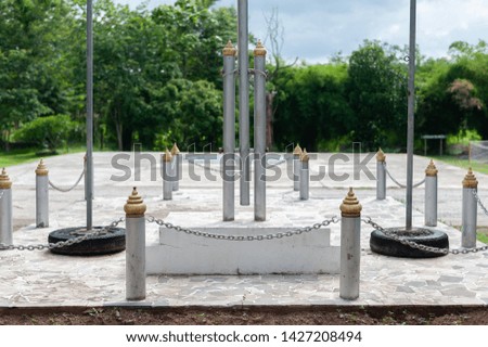 Large national flag poles surrounded by small pillars