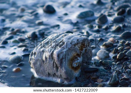 Taken pictures as the water touches shores on rocks.