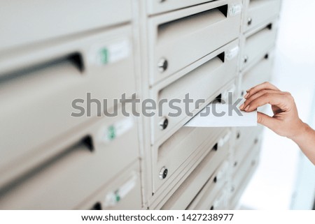 Sending a letter, close-up of a hand and letter.