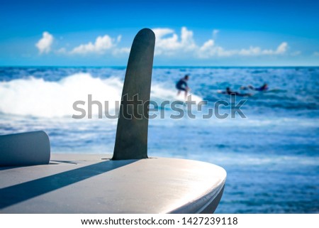 Surfer desk and blurred background of sea with blue sky. Summer time and water sports. 