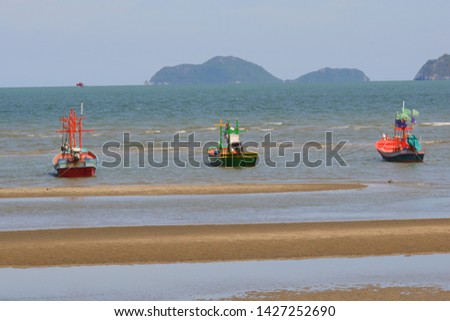 Fishing boats parked on the beach During low tide