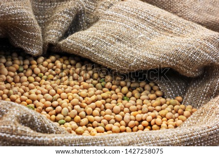 dried seeds of yellow soy in a canvas bag. close-up Royalty-Free Stock Photo #1427258075