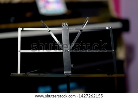 Music stand on blur piano background