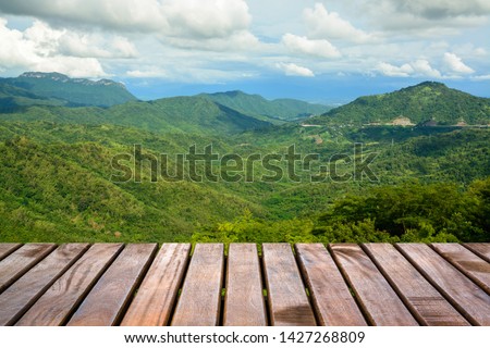 Wooden balcony with a beautiful view of the mountain and forest