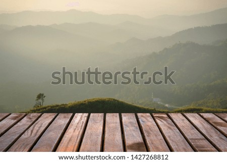 Wooden balcony with a beautiful view of the mountain and fog in the morning