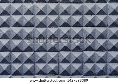 concrete wall texture stucco cement white and gray geometric seamless triangle pyramid background with shadow and light.
