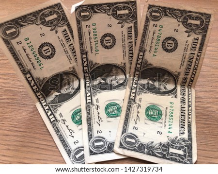 paper one dollar bills on a light background